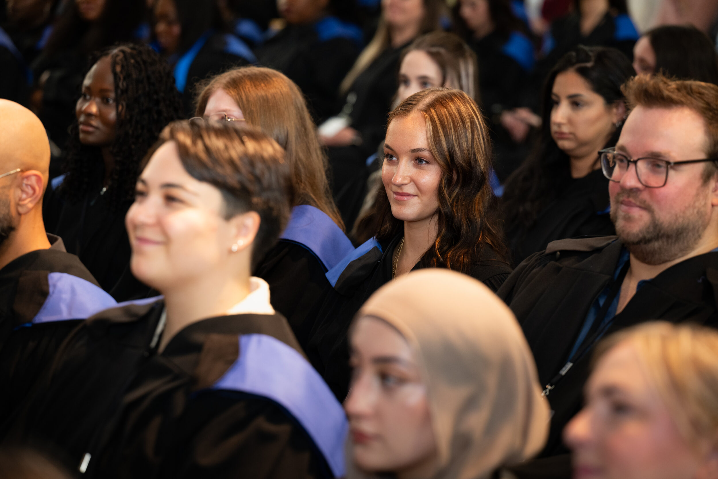 Graduates smile during the convocation ceremony.