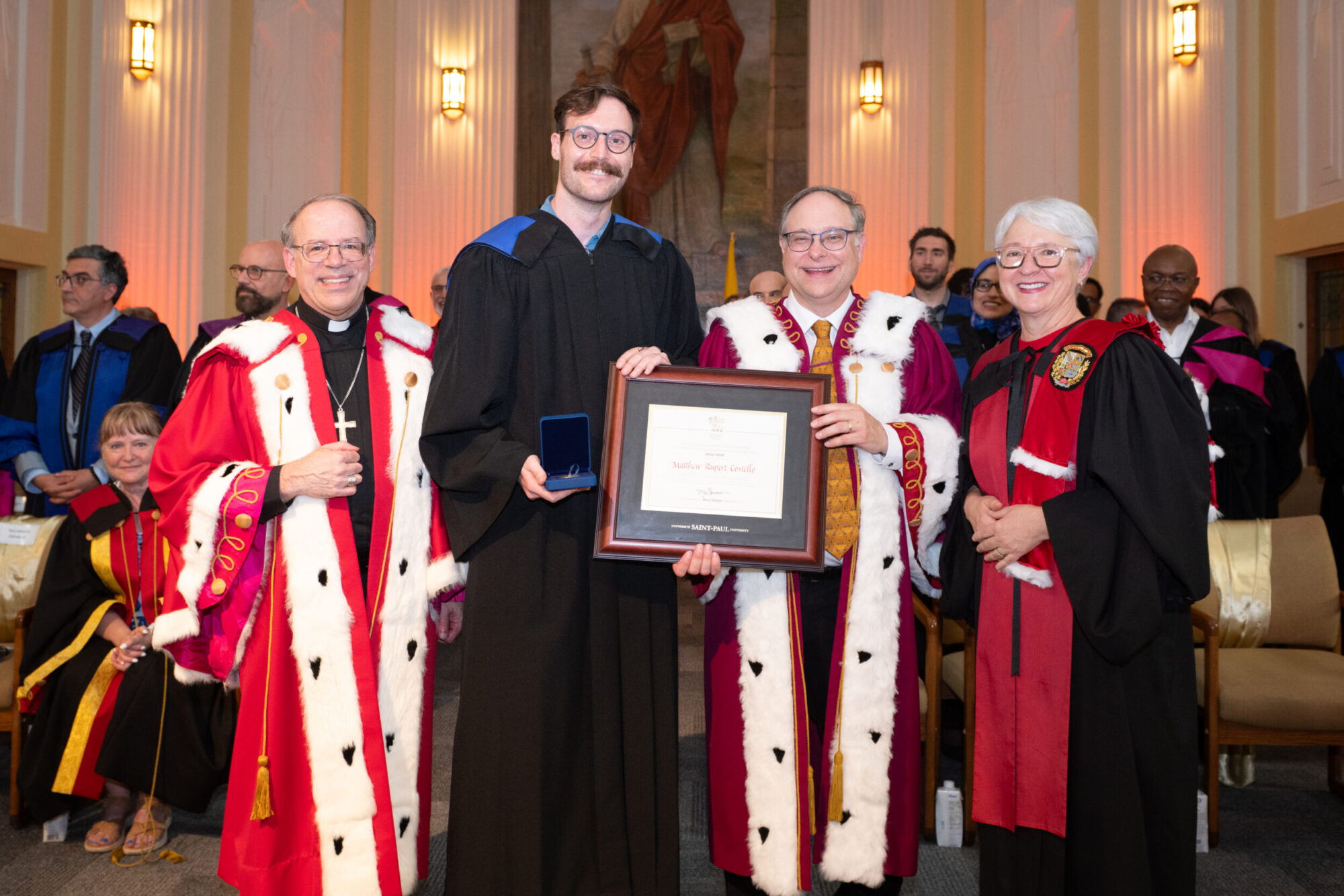 Costello Matthew Rupert receives the Governor General's Academic Silver Medal alongside Saint Paul University officials.