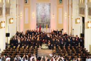 Graduates and faculty of the afternoon ceremony gather for a group photo in the De Mazenod Chapel.