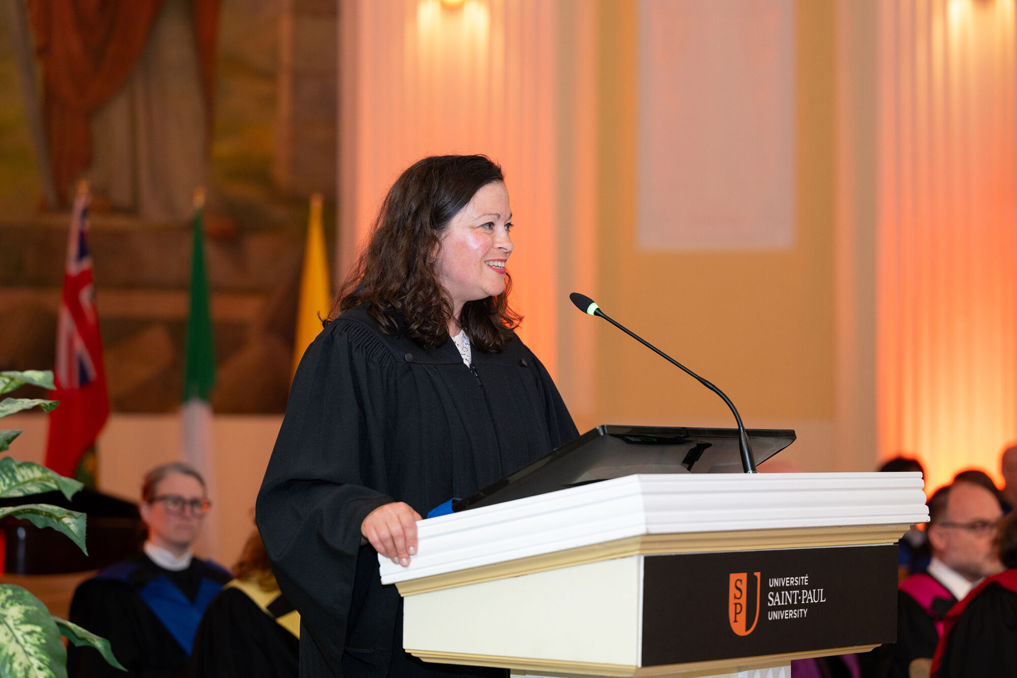 Dr. Natalie Dupuis delivers the valedictory address at the morning ceremony.
