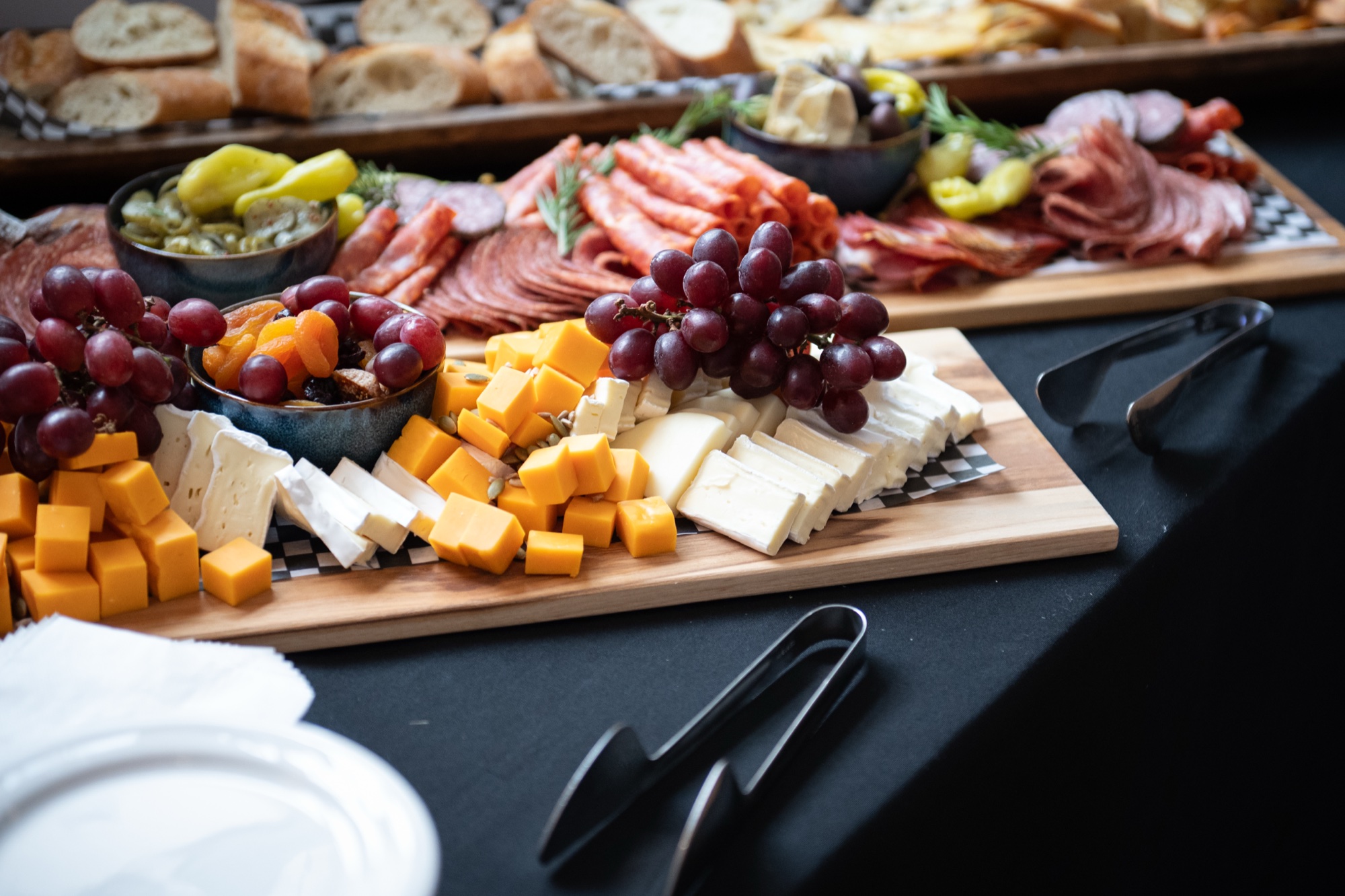 Charcuterie, cheese and grapes on serving boards