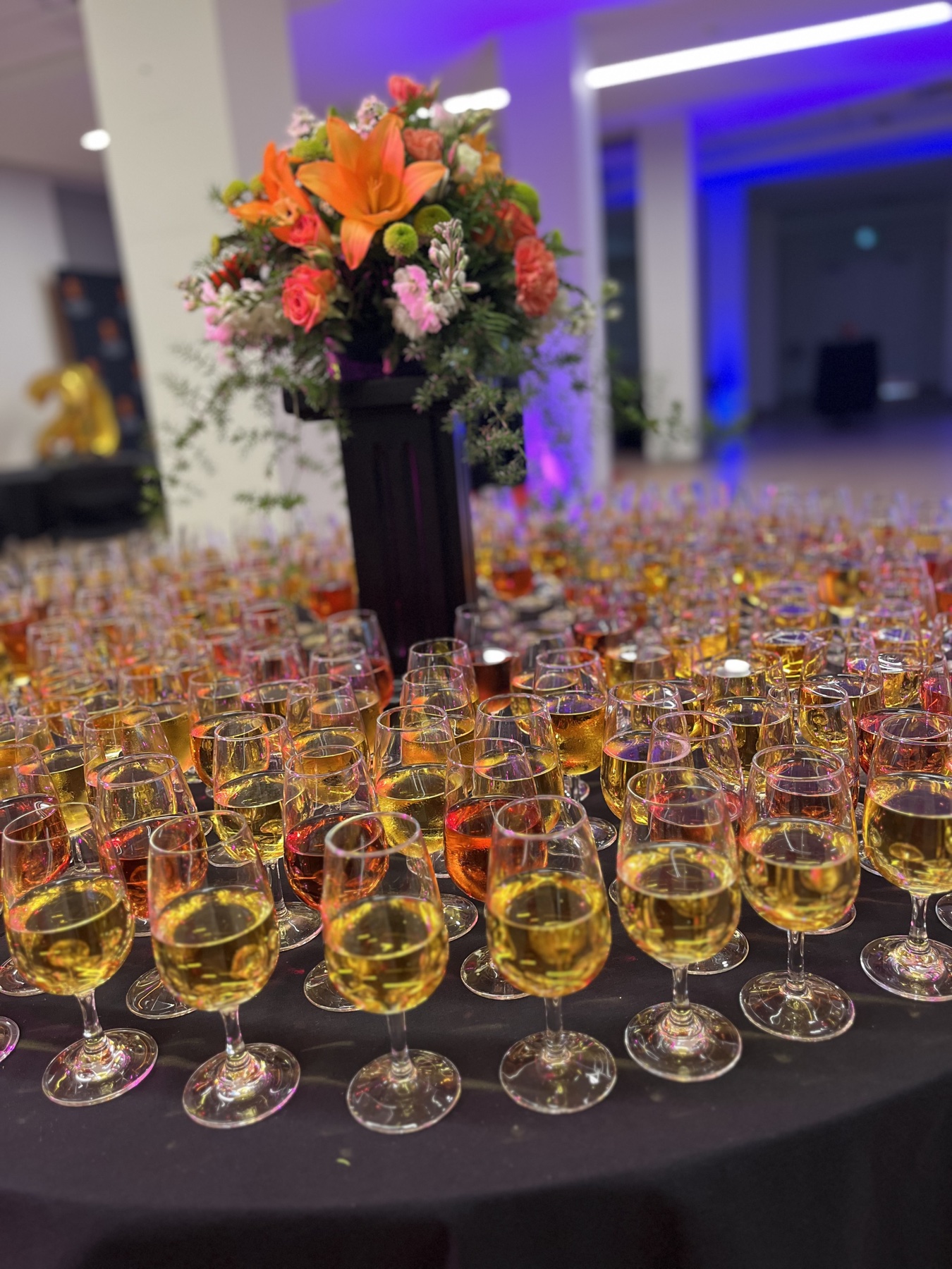 Glasses of wine and a floral centrepiece at a reception